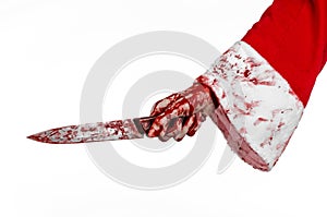 Christmas and Halloween theme: Santa's bloody hands of a madman holding a bloody knife on an isolated white background