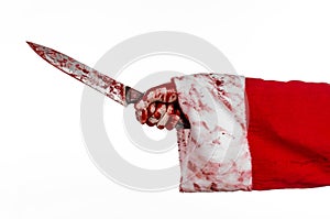 Christmas and Halloween theme: Santa's bloody hands of a madman holding a bloody knife on an isolated white background