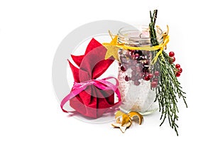 Christmas hand made candle with red berries craft and a gift isolated on white