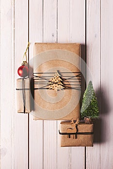 Christmas handcraft gift boxes on wood background.
