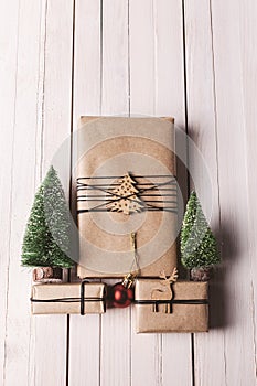 Christmas handcraft gift boxes on wood background.