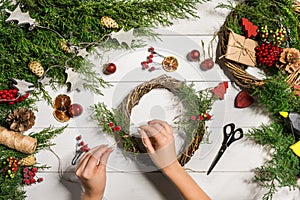 Christmas handmade diy background. Making craft xmas wreath and ornaments. Top view of white wooden table with female