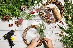 Christmas handmade diy background. Making craft xmas wreath and ornaments. Top view of white wooden table with female