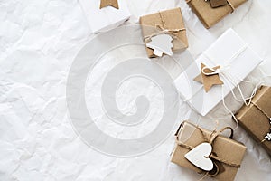 Christmas handmade gift boxes on white background top view. Merry Christmas greeting card, frame. Winter xmas holiday theme.