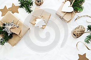 Christmas handmade gift boxes on white background top view. Merry Christmas greeting card, frame. Winter xmas holiday theme.