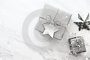 Christmas handmade gift boxes on white marble background top view. Merry Christmas greeting card, frame. Winter xmas holiday theme