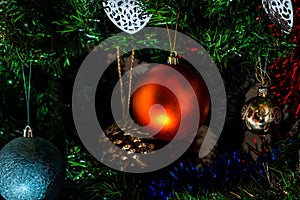 Christmas hanging decorations on fir tree. Decorated Christmas tree. Fir branch with Christmas baubles decorations