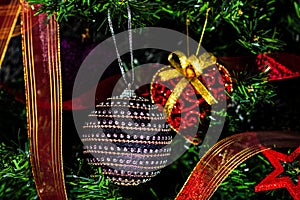 Christmas hanging decorations on fir tree. Decorated Christmas tree. Fir branch with Christmas baubles decorations