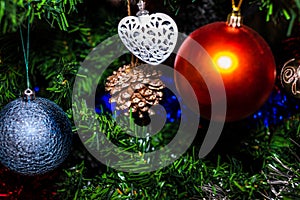 Christmas hanging decorations on fir tree. Decorated Christmas tree. Fir branch with Christmas baubles decorations