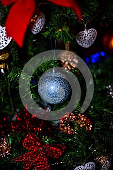 Christmas hanging decorations on fir tree. Decorated Christmas tree. Fir branch with Christmas baubles decorations