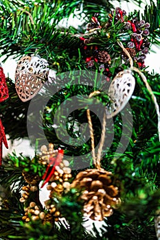 Christmas hanging decorations on fir tree. Decorated Christmas tree. Fir branch with Christmas baubles decorations