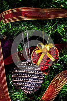 Christmas hanging decorations on fir tree. Decorated Christmas tree. Fir branch with Christmas baubles decorations