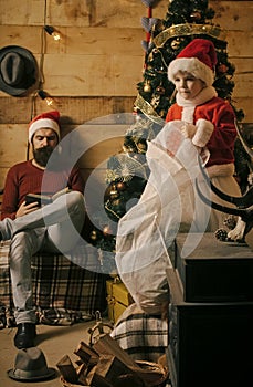 Christmas happy child and father read book.