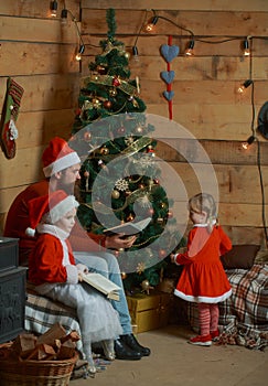 Christmas happy children and father read book