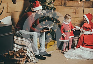 Christmas happy children and father read book.