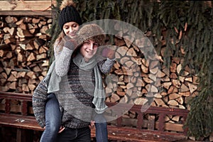 Christmas happy couple in love embrace in snowy winter cold forest, copy space, new year party celebration, holiday and