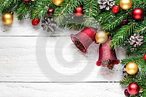 Christmas or happy new year background made of fir branches, decorations, red berries and pine cones