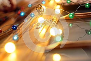 Christmas and Happy new year on blurred bokeh banner background of a luminous garland. Christmas lights background. New Year`s