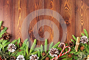 Christmas and Happy New Year dark brown background. Top view, copy space, wooden rustic table, fir branches