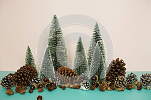 Christmas and happy new year holidays background with Christmas trees and pine cone on pink and blue background