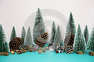 Christmas and happy new year holidays background with Christmas trees and pine cone on pink and blue background