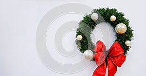 Christmas, happy new year wreath decoration with green leaves, ball and red ribbon isolated on white background with copy space.