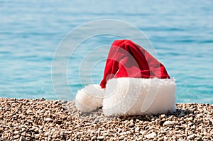 Christmas hat lies on the beach.