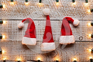 Christmas hats and decorative lights frame background