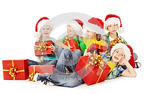 Christmas helpers kids in Santa hat holding presen