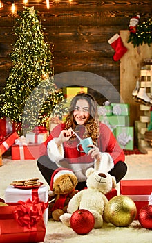 Christmas is here. happy girl drink milk with xmas cookies. woman sweater at presents. winter holiday gift and
