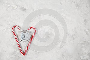 Christmas holiday background with alarm-clock, Candy canes plast