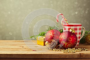 Christmas holiday background with checked cup and decorations over blur dreamy background