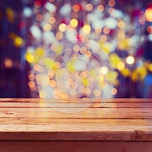 Christmas holiday background with empty wooden deck table over beautiful bokeh