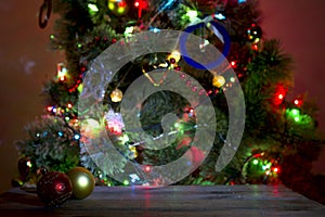 Christmas holiday background with empty wooden deck table over bokeh.