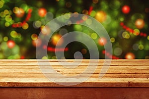 Christmas holiday background with empty wooden deck table over festive bokeh. Ready for product montage photo