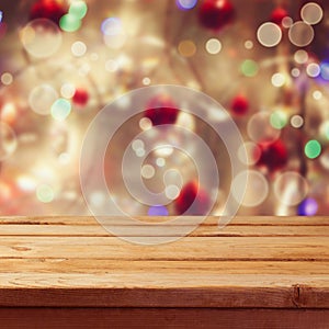 Christmas holiday background with empty wooden deck table over winter bokeh