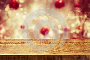 Christmas holiday background with empty wooden deck table over winter bokeh