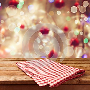 Christmas holiday background with empty wooden table and tablecloth.