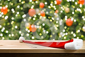 Christmas holiday background with empty wooden table top over christmas pine tree.