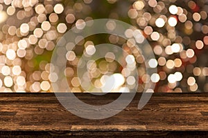 Christmas holiday background with empty wooden table top over festive bokeh light