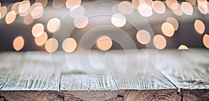 Christmas holiday background with empty wooden table top over festive bokeh light decorate