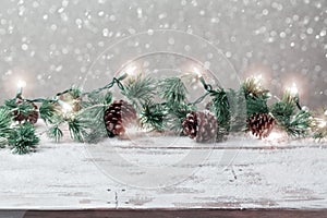 Christmas holiday background with empty wooden white table and Christmas festive lights