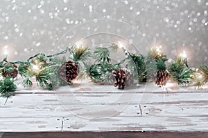 Christmas holiday background with empty wooden white table and Christmas lights