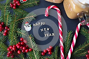 Christmas holiday background with hot cocoa and candy. The inscription Happy New Year