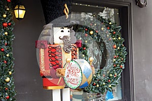 Christmas holiday background with nutcracker toy and Decorated shop window. Buying gifts and Souvenirs for festive