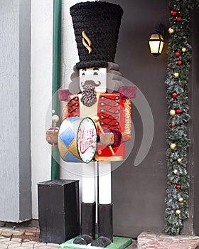 Christmas holiday background with nutcracker toy and Decorated shop window. Buying gifts and Souvenirs for festive