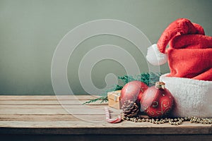 Christmas holiday background with Santa hat and decorations. Retro filter effect