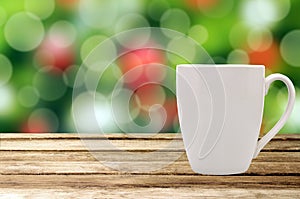 Christmas holiday background with wooden table and white tea cup