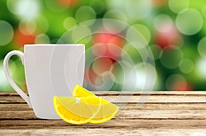 Christmas holiday background with wooden table and white tea cup