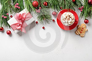 Christmas holiday border with gift, coffee, gingerbread, evergreen branches on white